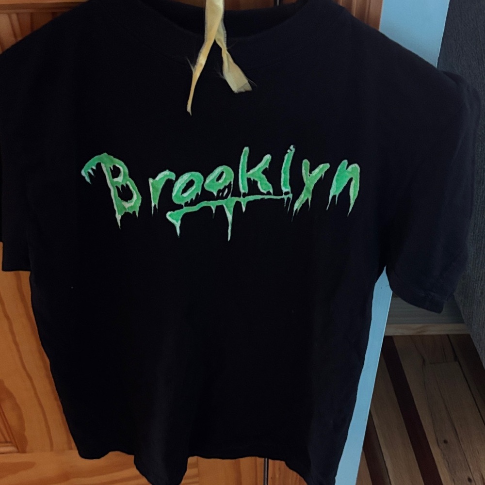 Kids Black and Green Graphic T-Shirt. On front says “Brooklyn” size M